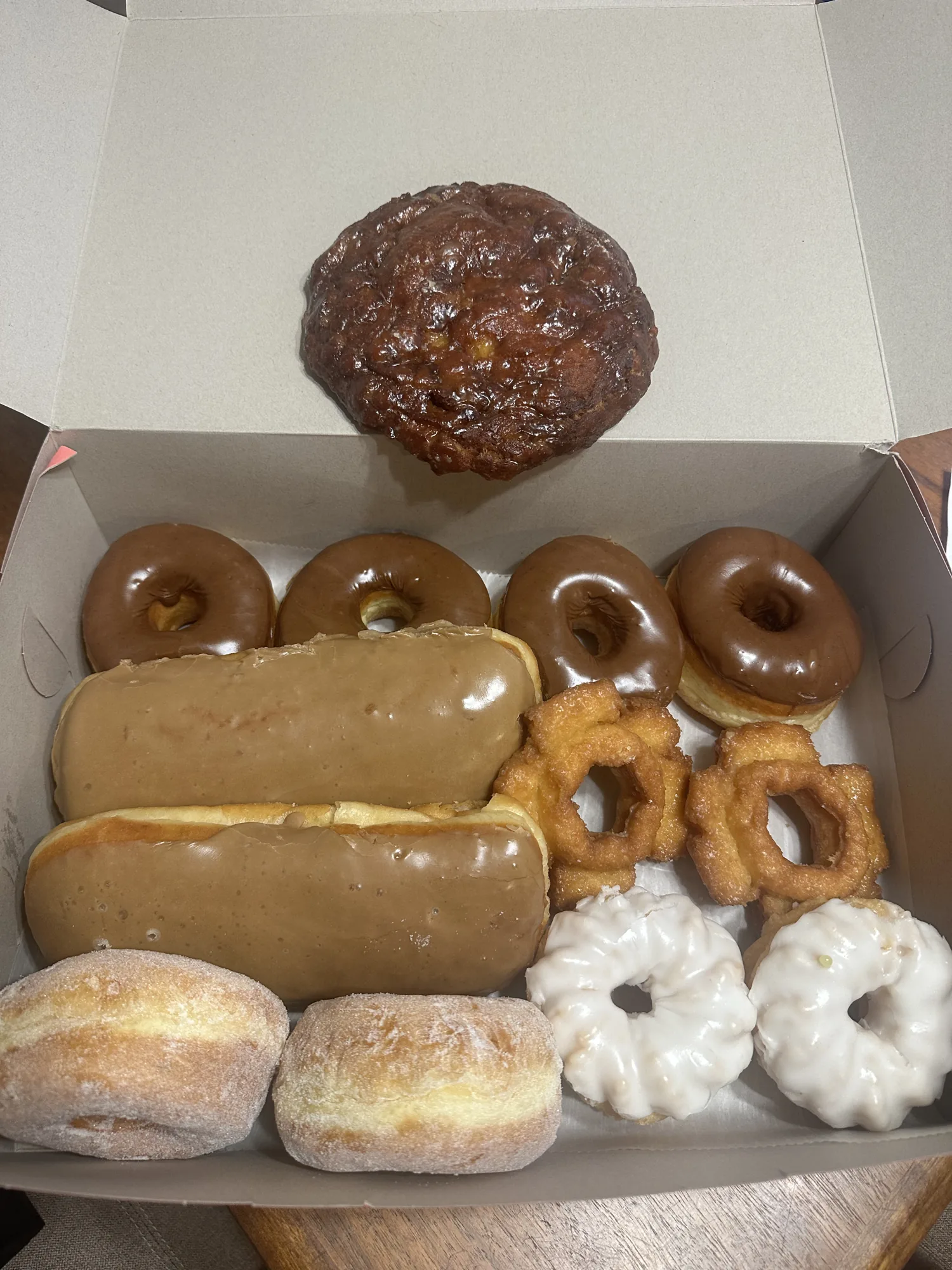Box of assorted donuts and an apple fritter in Bend, Oregon