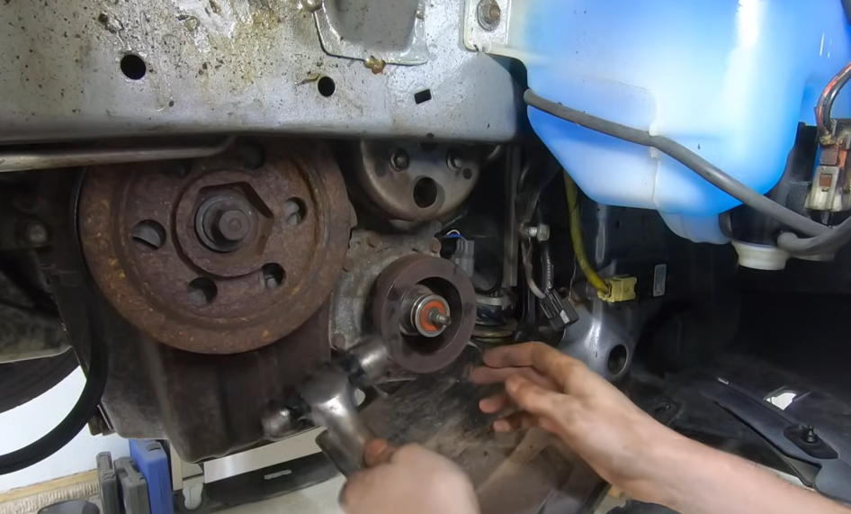 Auto mechanic working on a vehicle in an automotive repair shop